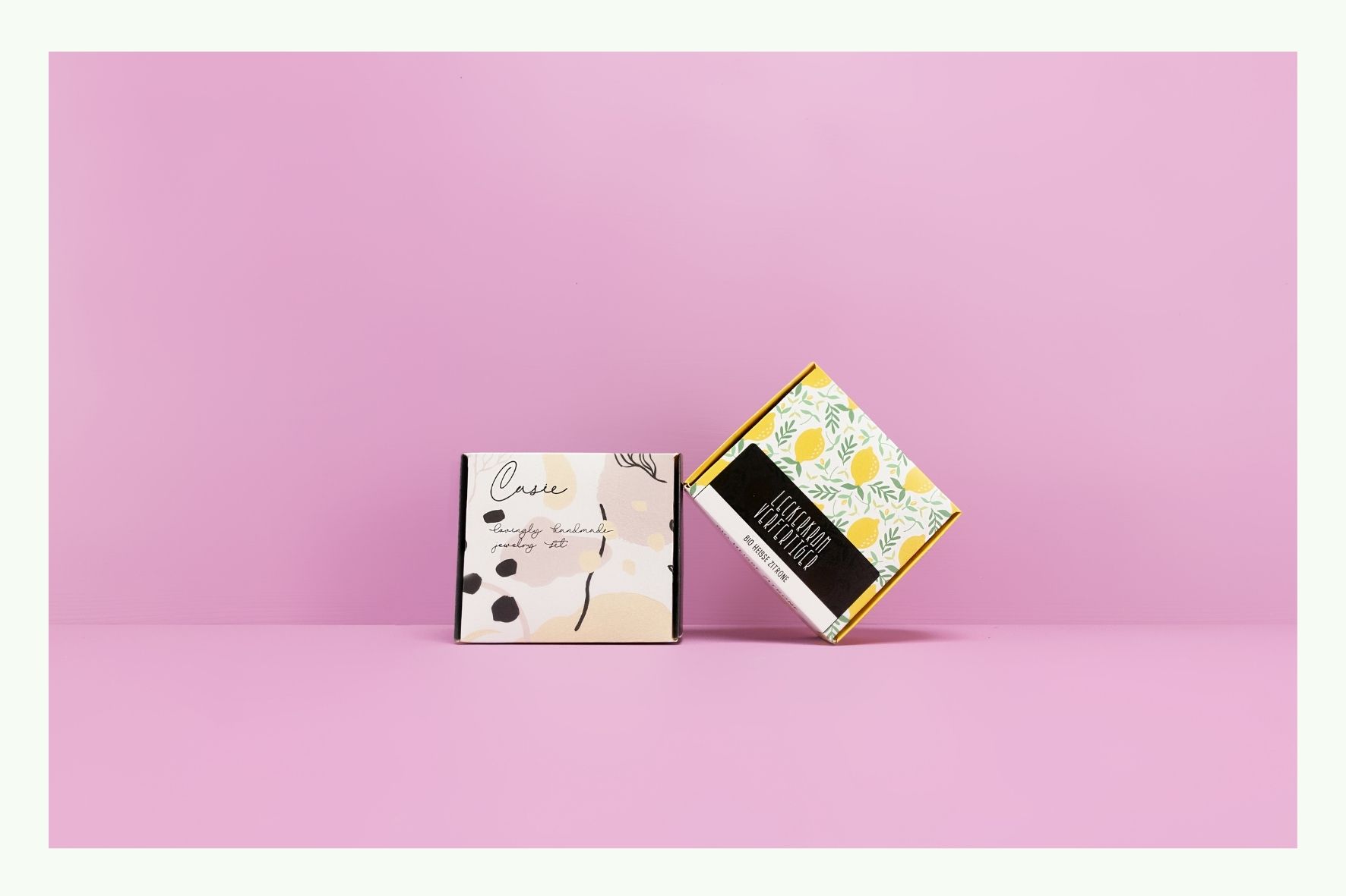 Due scatole pieghevoli con design floreale su sfondo rosa Due scatole pieghevoli con design floreale su sfondo rosa