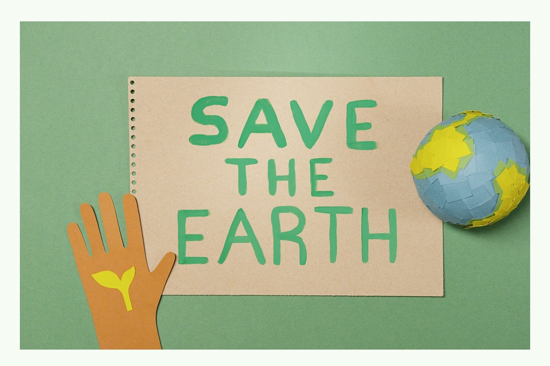Mano con globo e cartello Save the Earth Mano con globo e cartello Save the Earth